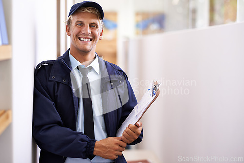 Image of Portrait, smile and retail with courier man at office for distribution, shipping or service. Ecommerce, logistics or delivery and happy young postal worker with clipboard for manifest or order