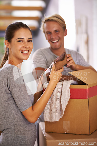 Image of House, couple and smile with box for moving in with clothes, satisfied and property ownership. Family, people and packing furniture in new home with investment, real estate for growth and future.