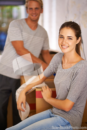 Image of Couple, moving and portrait of packing a box and excited for new house and preparing for property. People, unboxing and happy to rent real estate, apartment and start of marriage in home together