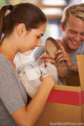 Image of Couple, packing and moving clothes in box and excited for new house and preparing for property. People, unboxing and happy to rent real estate, apartment and start of marriage in home together