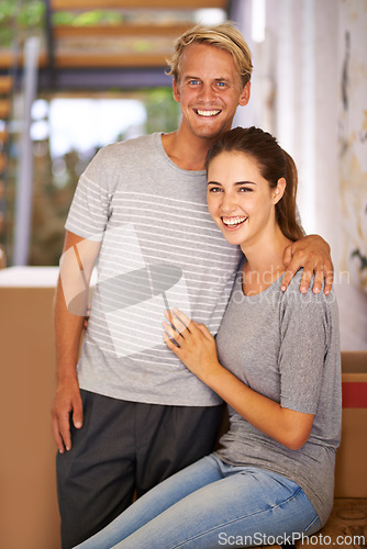 Image of Portrait, moving and happy couple for real estate, new home and property investment in hallway of house. Mortgage loan, face of man and woman with hug for relocation, apartment and cardboard box.