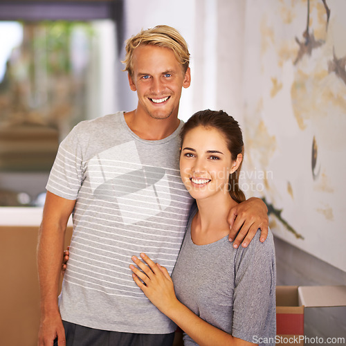 Image of Happy couple, moving and portrait for Mortgage loan, new home and property investment in hallway of house. Real estate, face of man and woman with hug for apartment, relocation and cardboard box.