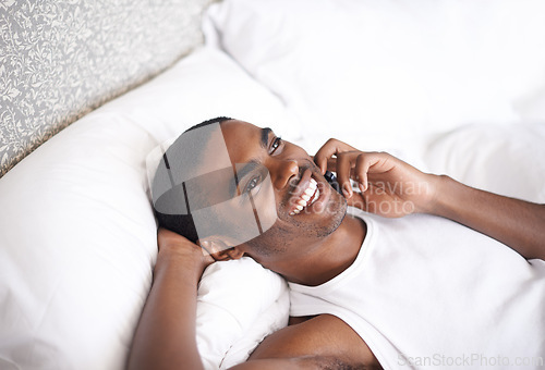 Image of Call, black man and laughing with phone in bed for funny conversation or communication at home. Face of African male person with smile on mobile smartphone for fun discussion or relax in the bedroom