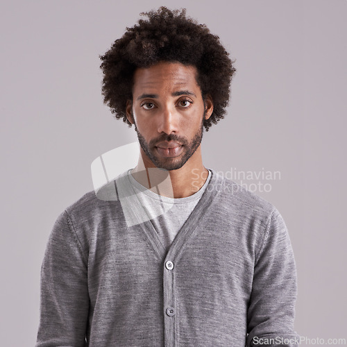 Image of Afro, studio and portrait of man with fashion for trendy, clothes and cool style on gray background. Jersey, black person and serious face with confidence for style, fashionable and relaxing