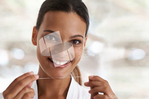 Image of Woman, dental and smile with floss, self care and portrait for health in bathroom. Person, cleaning and healthcare for teeth, oral hygiene and routine at home or house with dentistry and whitening