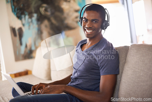 Image of Man, portrait or radio with laptop on sofa for internet streaming, happiness or online research with music. Student, black person or technology with headphones for relax, studying or learning in home