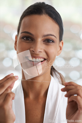 Image of Woman, teeth and smile with floss, self care and portrait for health in bathroom. Person, cleaning and healthcare for dental, oral hygiene and routine at home or house with dentistry and whitening