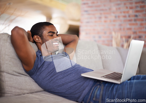 Image of Home, smile and black man with laptop, relax and connection with digital app or internet. African person, apartment or guy with computer or social media with online movie and entertainment in lounge