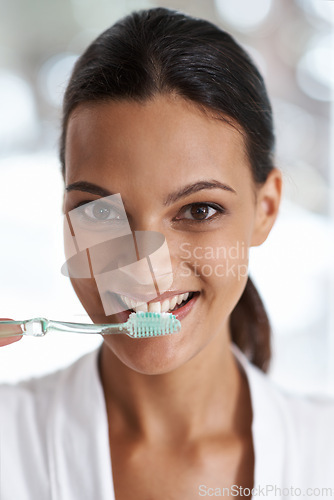 Image of Woman, brushing teeth and toothbrush for dental, portrait with smile in bathroom for morning routine. Oral hygiene, wellness and orthodontics with toothpaste for fresh breath, health and self care