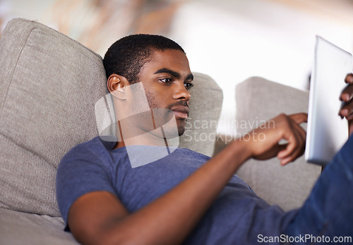 Image of Home, relax and black man with tablet, typing and connection with social media and internet. African person, apartment and guy with technology or digital app with website information or entertainment