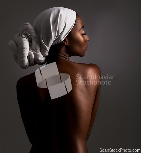 Image of Beauty, body and heritage with natural black woman in studio on gray background for wellness. Skincare, culture or tradition and aesthetic young model in Africa for cosmetics or dermatology from back