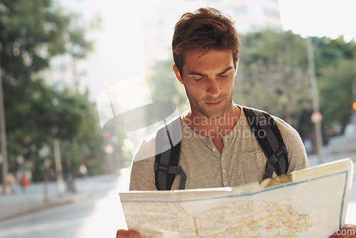 Image of Man, city and tourist with map for destination, location or tour guide in street or road. Male person or traveler looking at geographic paper on adventure route, journey trail or outdoor path in town
