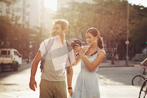 Image of Couple, tourist and photography in street for travel, sightseeing and happiness on holiday or vacation in Brazil. Camera, man and woman with smile in city road for explore, tourism or journey in town