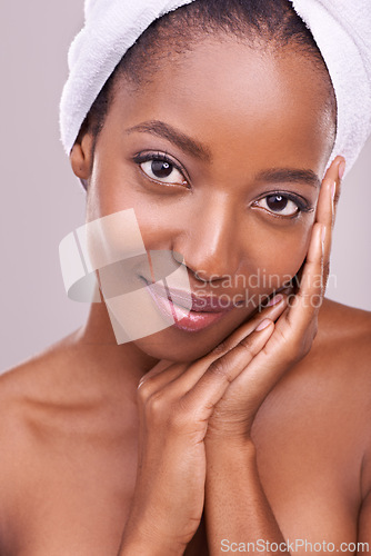 Image of Woman, face and towel for skincare in studio with beauty, dermatology and facial glow on a white background. Portrait of young model or African person smile for hygiene, cosmetics or natural makeup