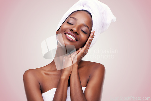 Image of Black woman, skin care and dreaming for beauty, studio and wellness in fresh look with smile and face touch. African female person, cosmetic and glow for anti age, towel and natural confidence