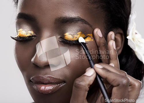 Image of Brush, makeup and face of black woman in studio for wellness, beauty and aesthetic. Cosmetology, skincare and person with tools for makeover application, eyeshadow and products on a white background