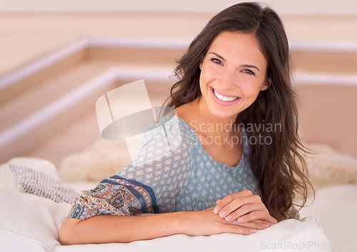 Image of Woman, smile and excited in portrait on sofa to relax in home with pride, holiday and confidence in living room. Person, happy and break on vacation in lounge with couch at apartment in Barcelona