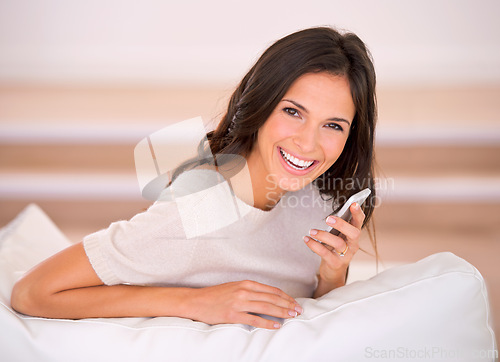 Image of Woman, phone call and speaker with smile on sofa in living room for talking, portrait and chat in home. Person, cellphone and happy for mobile network with connection on lounge at house in Barcelona