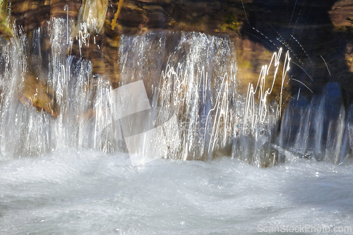 Image of Close-up view of a serene waterfall cascading over rocky ledges 