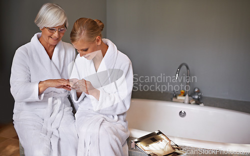 Image of Mother, spa and manicure with daughter, bath and senior woman for bonding and relaxation. Parent, robe and nail polish with cosmetics, guidance and support with beauty treatment or pamper and glasses