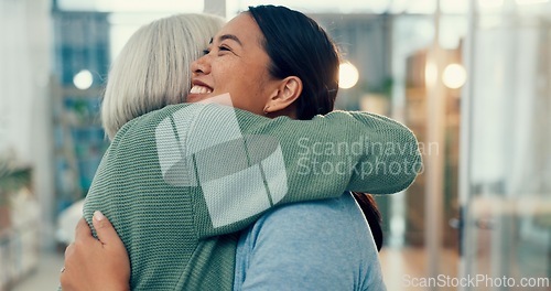 Image of Senior woman, hug and old friend at a business office with a smile, support and excited. Elderly person, love and happy women together at a workplace with care from staff at physiotherapy with health