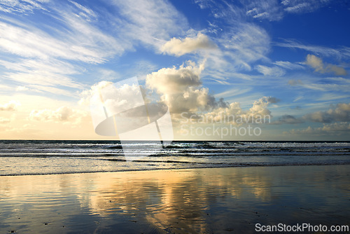 Image of Sunset, beach and clouds on landscape in nature, evening sun and calm ocean with blue sky. Waves, summer skyline and peaceful environment with island sand, zen location and vacation horizon in Miami