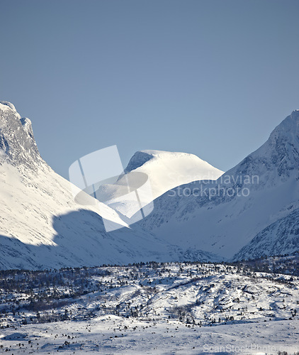 Image of Mountain, blue sky and snow in winter with landscape of nature, environment and cold weather outdoor. Icy ground, natural background with travel or tourism, ice with frozen location or destination