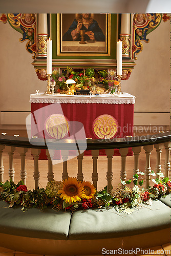 Image of Christian, shrine or altar in church for religion, worship and spiritual space for Catholic ceremony or culture. Praise, god and painting of Jesus in chapel with candles and holy bible on table