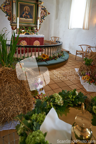 Image of Christian, shrine or altar in church for religion, worship and spiritual festival or ceremony in Danish culture. Praise, god and painting of Jesus in chapel interior with flowers and holy decoration