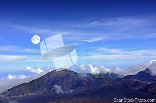 Image of Mountain, clouds and natural landscape with blue sky, horizon and summit for travel destination. Nature, sustainable environment and volcano for adventure, explore or summer vacation in Hawaii.