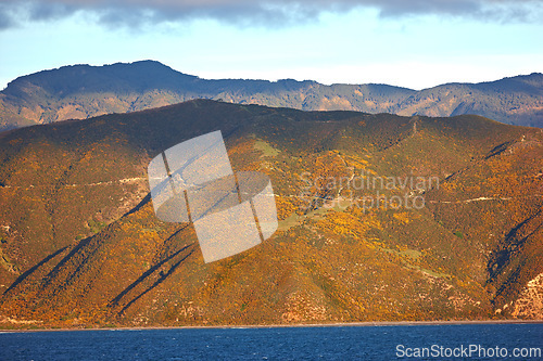 Image of Mountain, ocean and natural landscape with cloudy sky, summer and calm island on peak at travel location. Nature, cliff and sustainable environment with earth, sea and tropical holiday destination