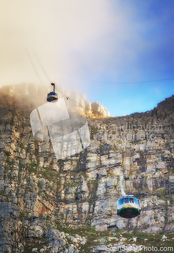 Image of Nature, clouds and blue sky with aerial cable car on Table Mountain for outdoor adventure, travel destination and sightseeing. Low angle, national landmark and tourism for peace, calm and relax.