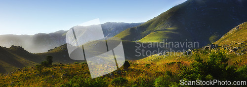 Image of Mountain, fog and natural hill with field, blue sky and calm landscape for travel location. Nature, green and sustainable environment with earth, peace and holiday destination with conservation