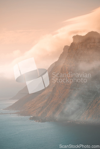 Image of Mountain, fog and ocean landscape with cliff, cloudy sky and tropical island sunset for travel location. Nature, sea and sustainable environment with earth, natural hill and holiday destination.