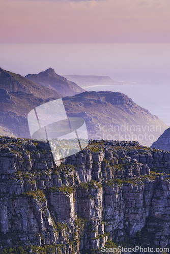 Image of Mountain, fog and sunset sky with color on horizon, natural landscape and calm cliff at travel location. Nature, ocean and sustainable environment with earth, peace and holiday destination on island