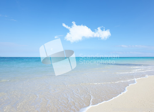 Image of Ocean, Bahamas and blue sky for holiday, sand and rocks in shore for peace and tranquility. Seaside, waves and summer for vacation, location and beach for clear water on travel and tropical trip