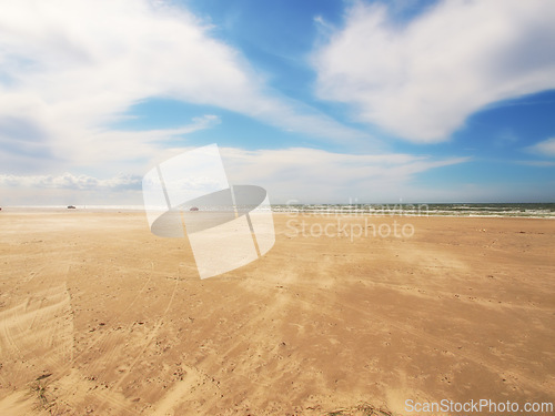 Image of Sand, beach and blue sky with clouds in nature for travel, vacation or holiday in Cape town. Landscape, ocean and water by seashore on tropical island for scenic outdoor summer weekend trip.