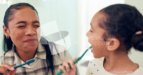 Image of Smile, brushing teeth and mother with daughter, morning routine and child development in bathroom. Happy family or mama with kid and dental with wellness or toothbrush with fresh breath and funny