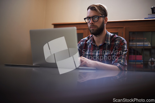 Image of Man, laptop and journalist with glasses in remote work, communication or networking at home. Male person, writer or freelancer working and typing on computer for online story or blog at the house