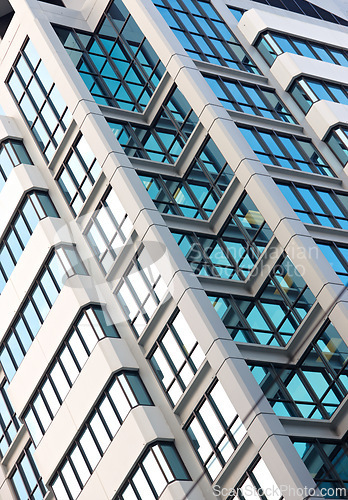 Image of Architecture, windows and skyscraper building with exterior design of industrial construction. Low angle view of outdoor city structure, concrete property or architectural detail in an urban town