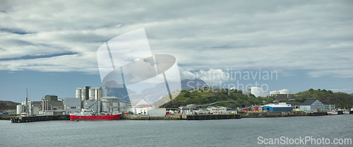 Image of Fishing, plant and industrial tank on water for processing, production and feed mill for fish industry in Norway. Manufacturing, containers and warehouse for agriculture and sea factory with harbour