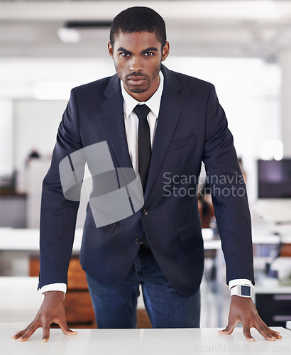 Image of Portrait, businessman and confident in office on mission and assertive in corporate career in workplace. Serious face, black person or entrepreneur with ambition or satisfaction in startup company