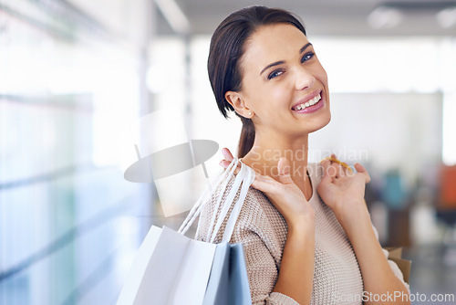 Image of Portrait, smile and woman with shopping bags for fashion, sales or discount at retail store for commerce. Face, customer and happy person with gifts at mall or boutique for purchase of casual clothes