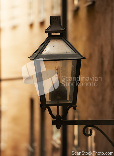 Image of Travel, architecture and lamp on retro building in old town with history, culture or holiday destination in Sweden. Vacation, landmark and antique lantern in Stockholm with vintage light ancient city