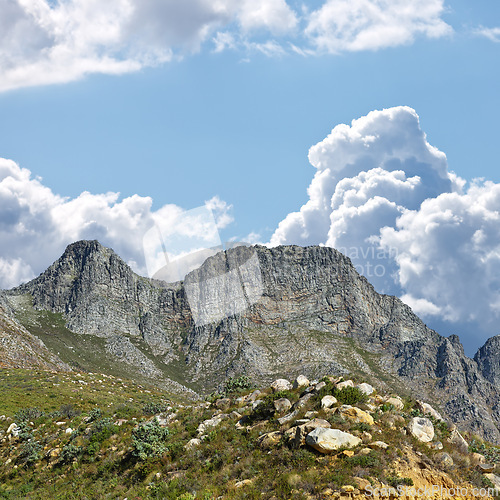 Image of Mountain, blue sky and travel location with clouds, summer and journey in natural landscape. Landmark, nature and environment for outdoor adventure, explore and holiday destination in South Africa.