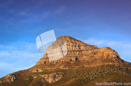 Image of Mountain, peak and natural landscape with blue sky, summer and calm cliff at tranquil travel location. Nature, evening and sustainable environment with earth, sunshine and serene hill in Cape Town