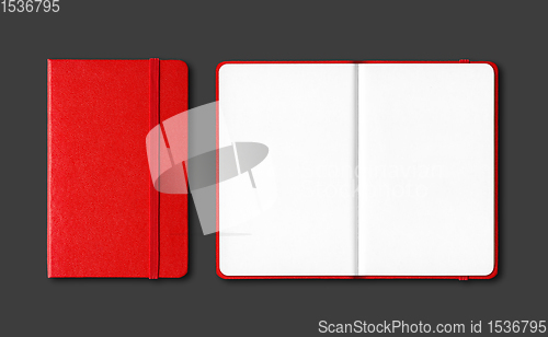 Image of Red closed and open notebooks isolated on black