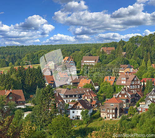 Image of Houses, village or countryside landscape, travel and adventure location with trees in nature and buildings outdoor. Neighborhood, real estate and property with architecture for holiday in Germany