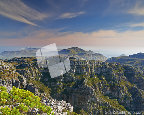 Image of Mountain, clouds and natural landscape with sky, sea and calm cliff at travel location. Nature, island peak and sustainable environment with earth, ocean and tropical holiday destination with fog