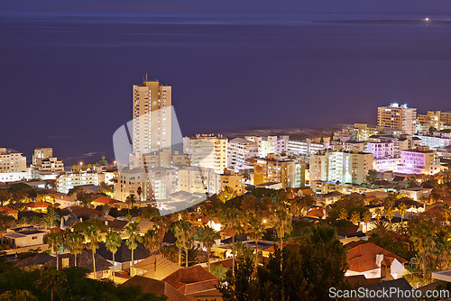 Image of Night, city and buildings with travel and view, architecture and skyscraper with outdoor landscape. Property, real estate and urban development, destination or location with skyline and background